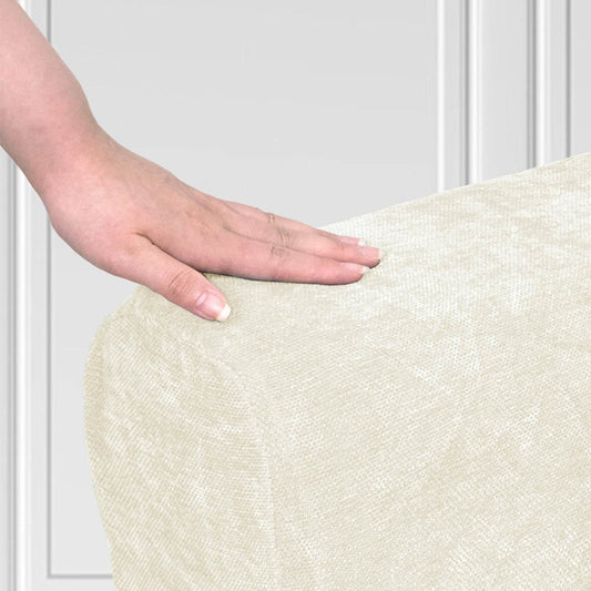 Close-up of a hand touching a textured chenille armrest cover, highlighting the soft, plush fabric and detailed weave.