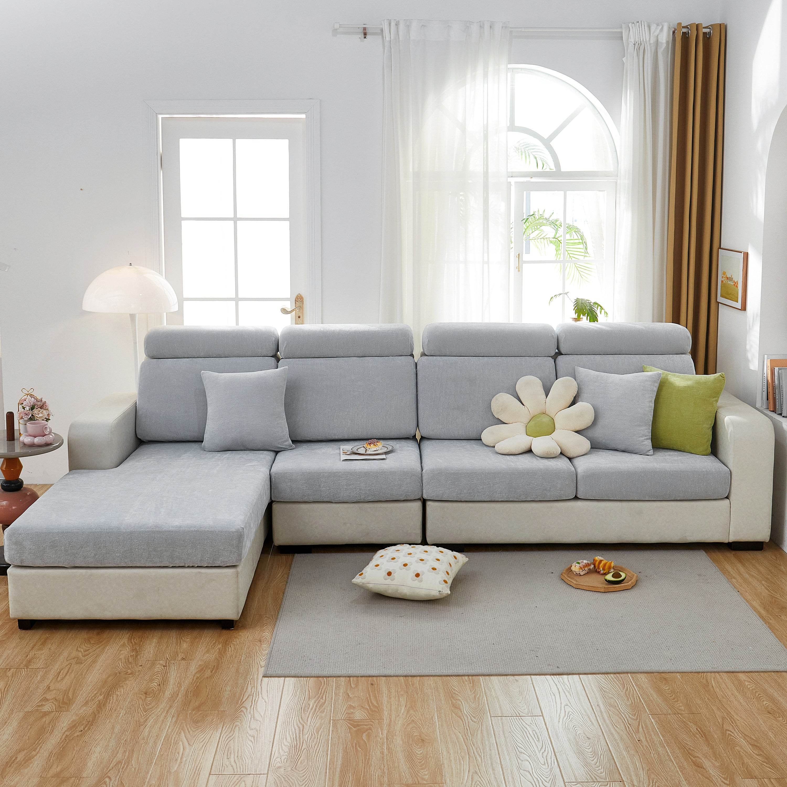 Full light gray sofa cover tightly fitted over a fabric couch, blending into a warm, pet-friendly living room