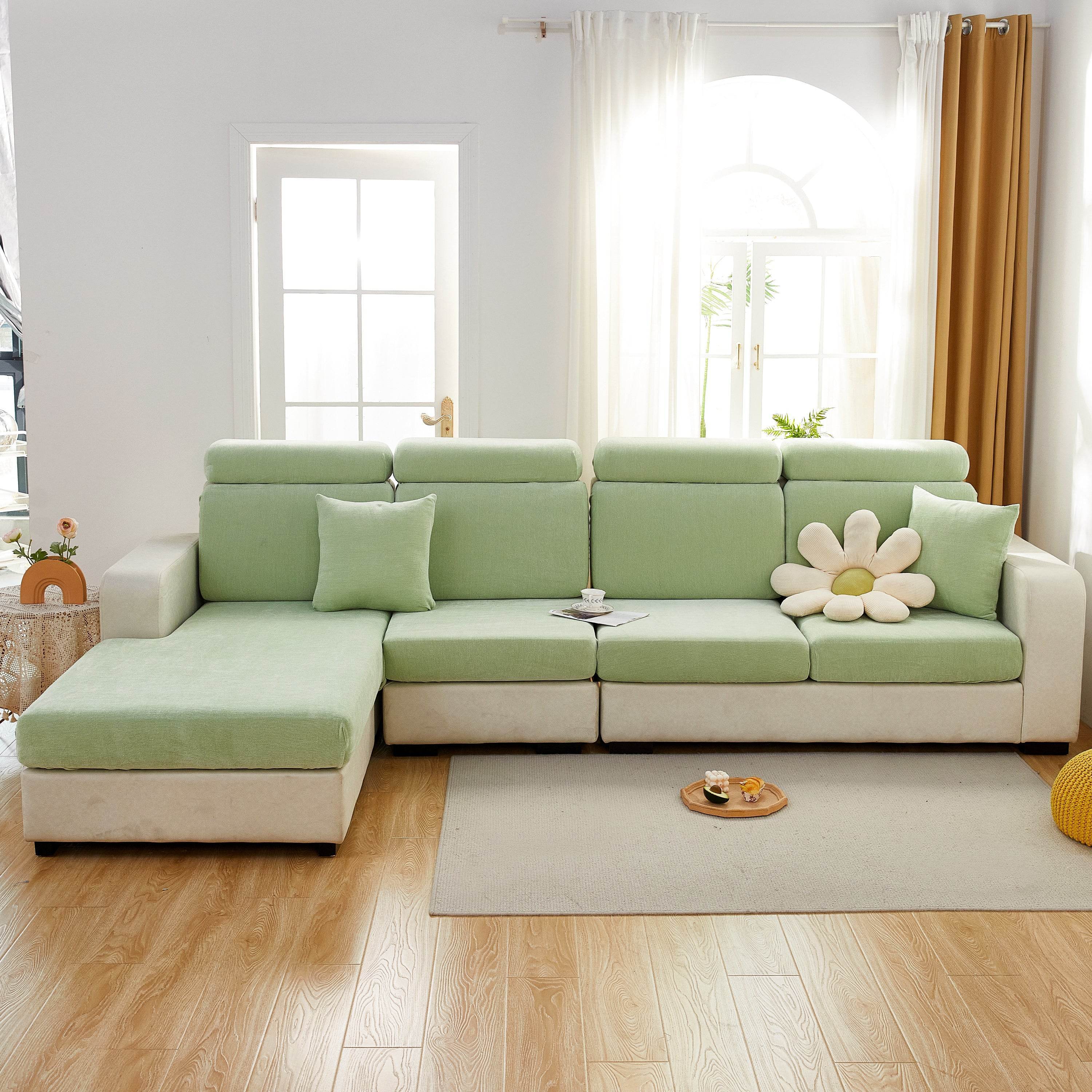 Full mint sofa cover tightly fitted over a fabric couch, blending into a warm, pet-friendly living room