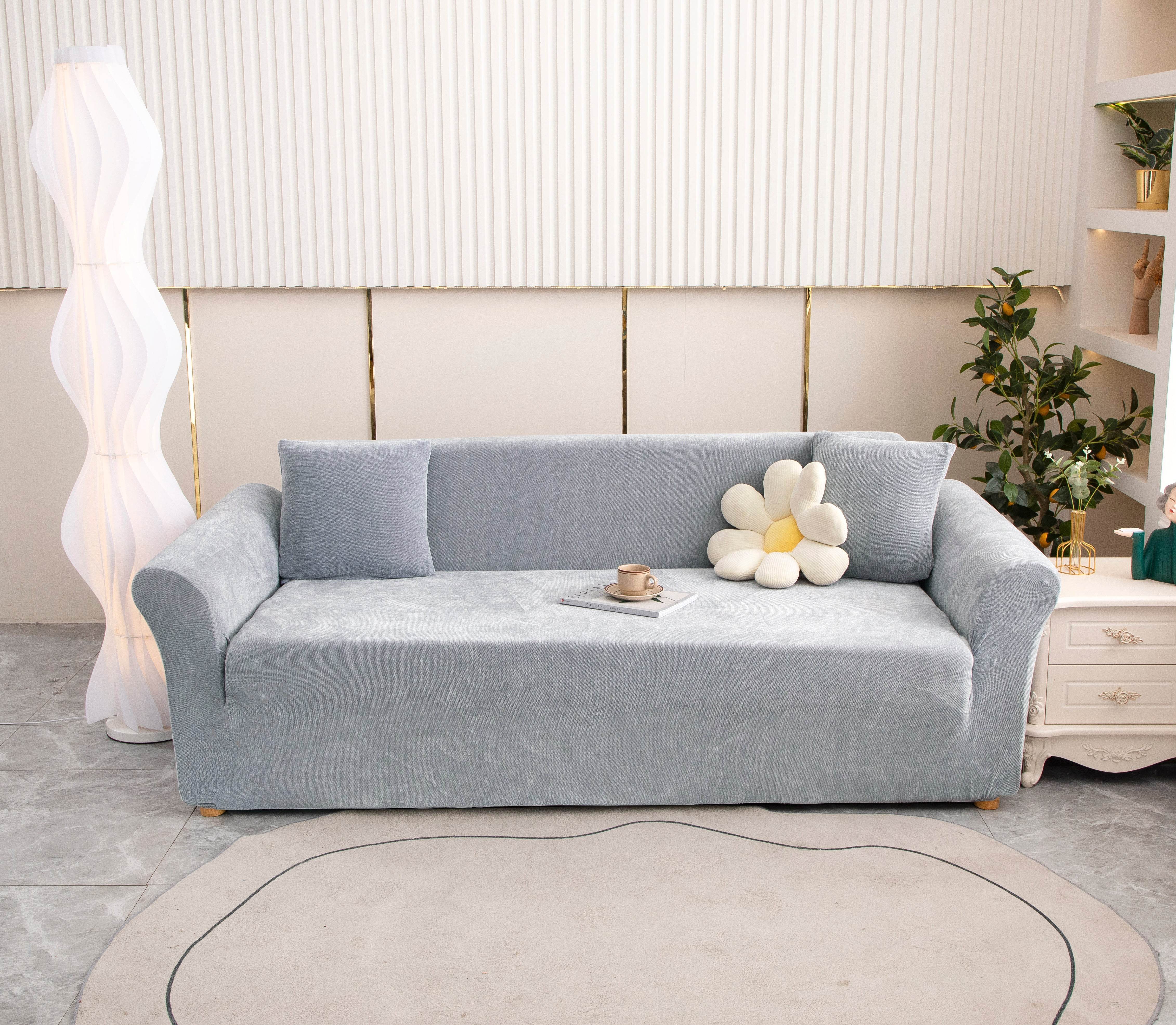Full view of dark gray Cozee Chenille slipcover fitted on a 3-seater sofa in a bright living room