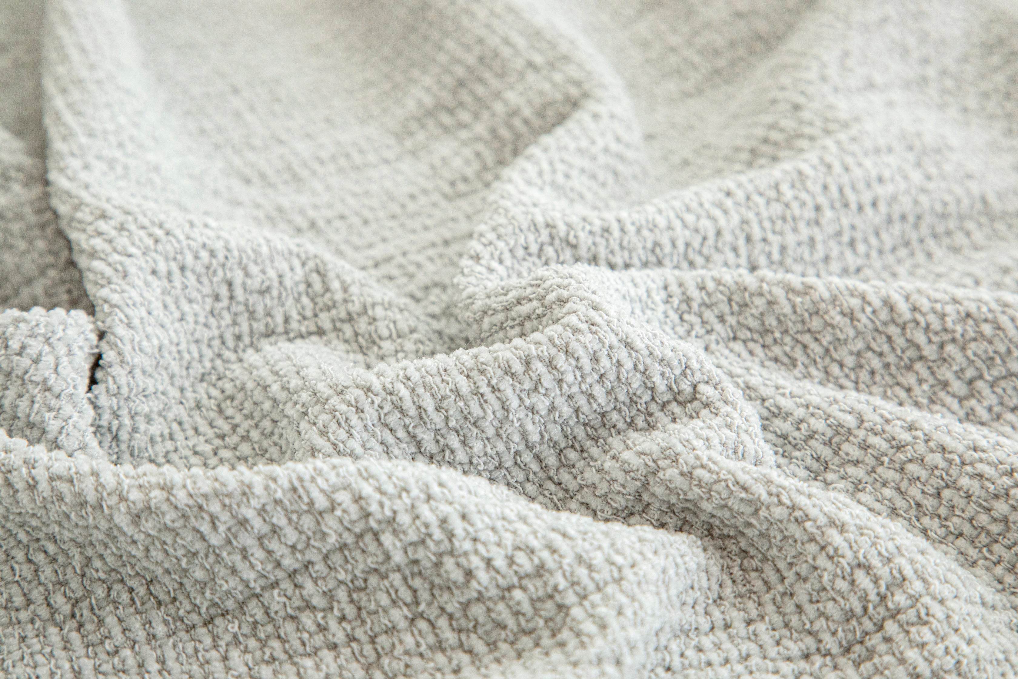 Close-up of the Cozee Chenluxe Sofa Cover showing its unique linen-like texture, plush chenille comfort, and durable luxurious weave.