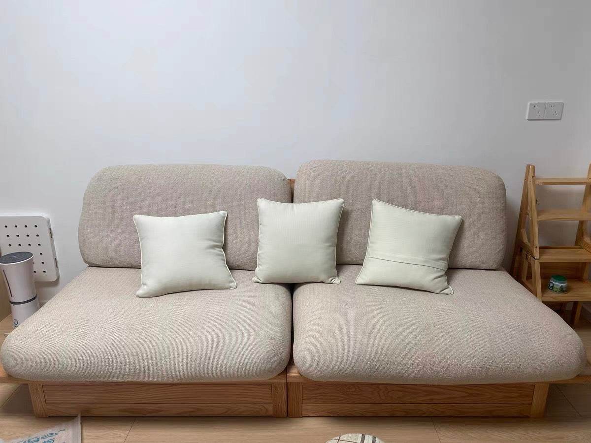 Real-life photo of the Cozee Chenluxe Sofa Cover styled in a living room, showing its plush chenille fabric, linen-like texture, and elegant full sofa protection.