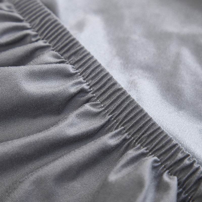Close-up of the Cozee Comfort Guard Slipcover showing visible stitching and soft fabric folds, highlighting its durable construction and flexible, form-fitting design