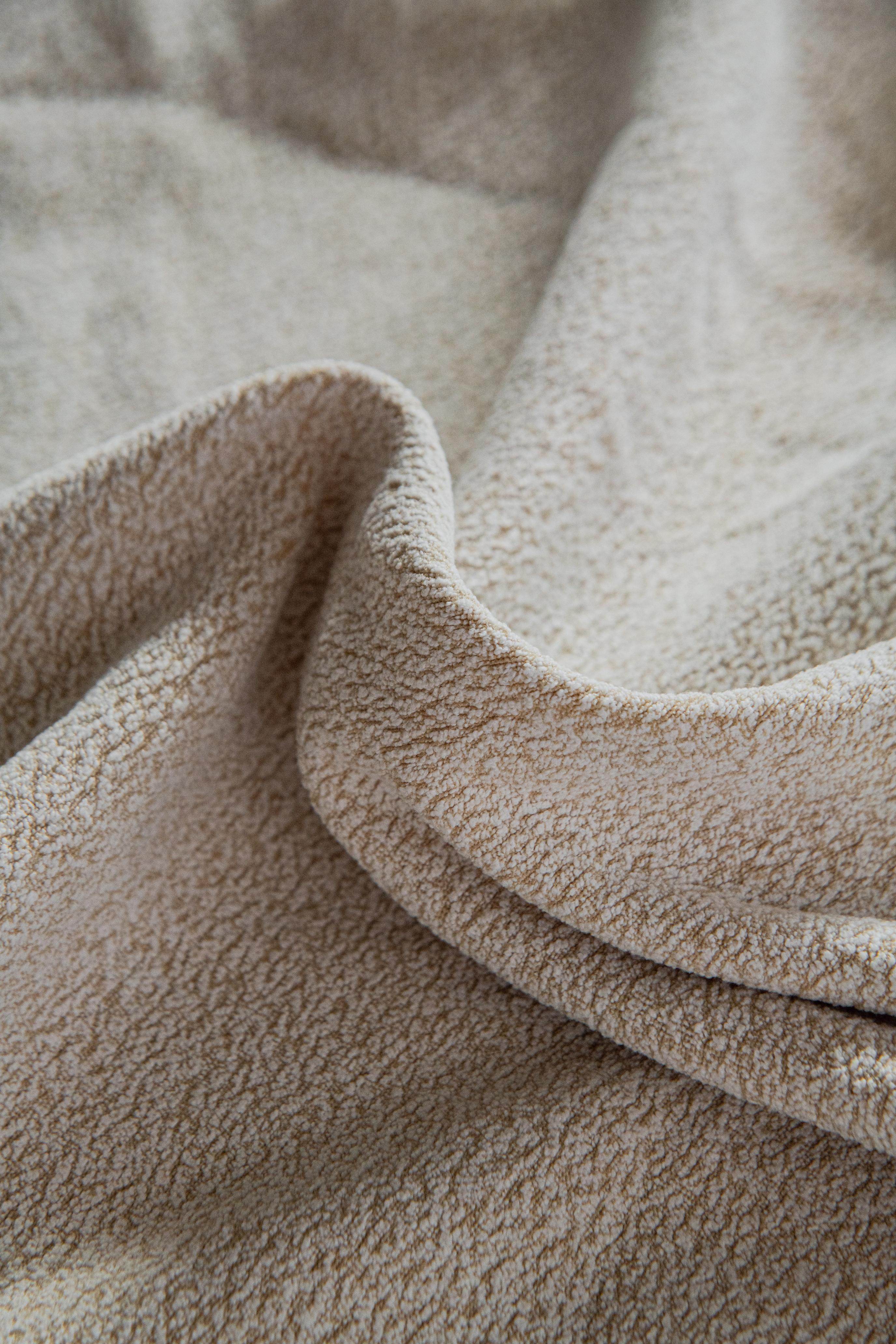 Close-up of the Cozee Cozura Sofa Cover showing thick chenille fabric with a soft, skin-friendly texture and durable weave for long-lasting comfort.