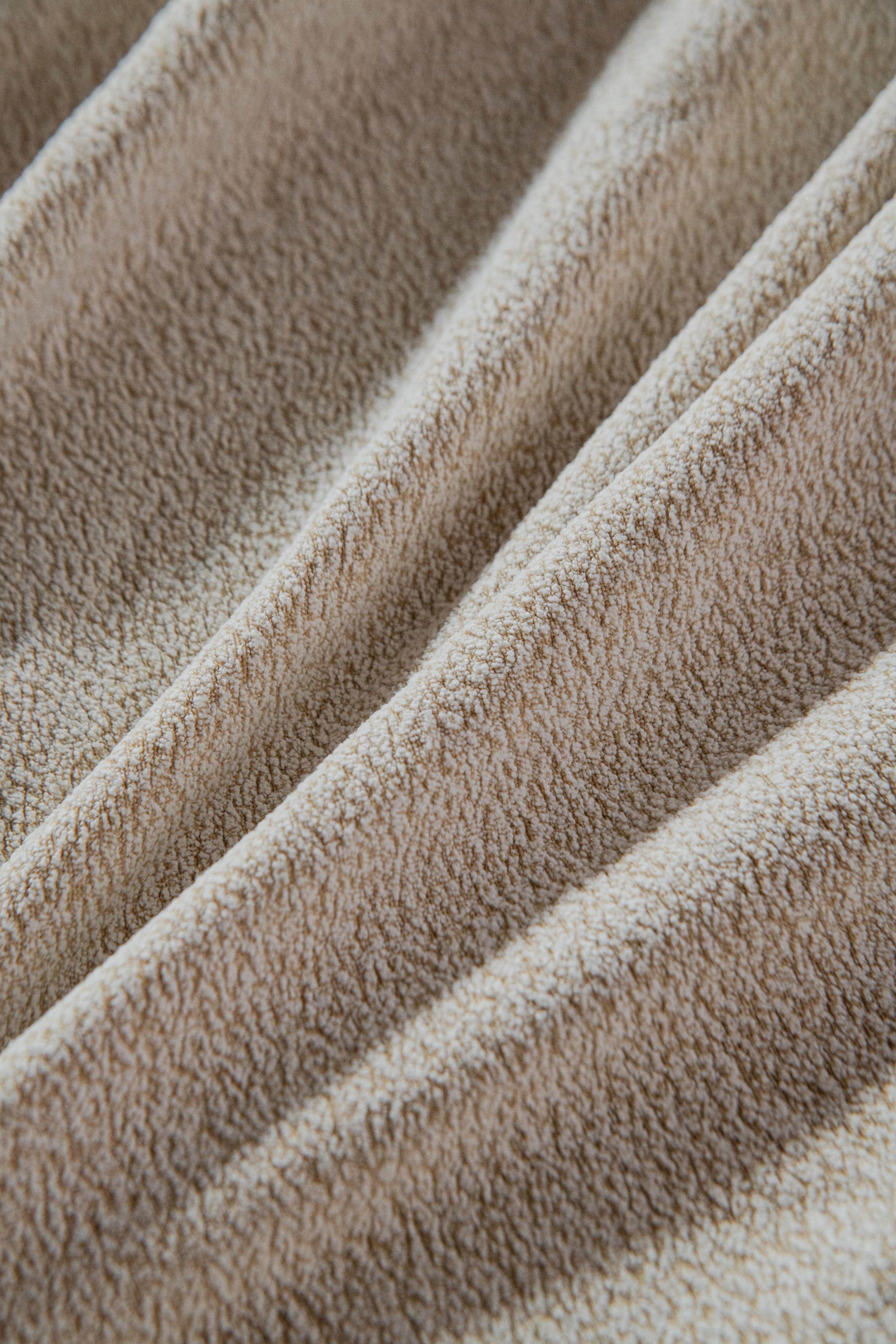 Close-up detail of the Cozee Cozura Sofa Cover highlighting the thick chenille weave, smooth skin-friendly surface, and cozy durable finish.