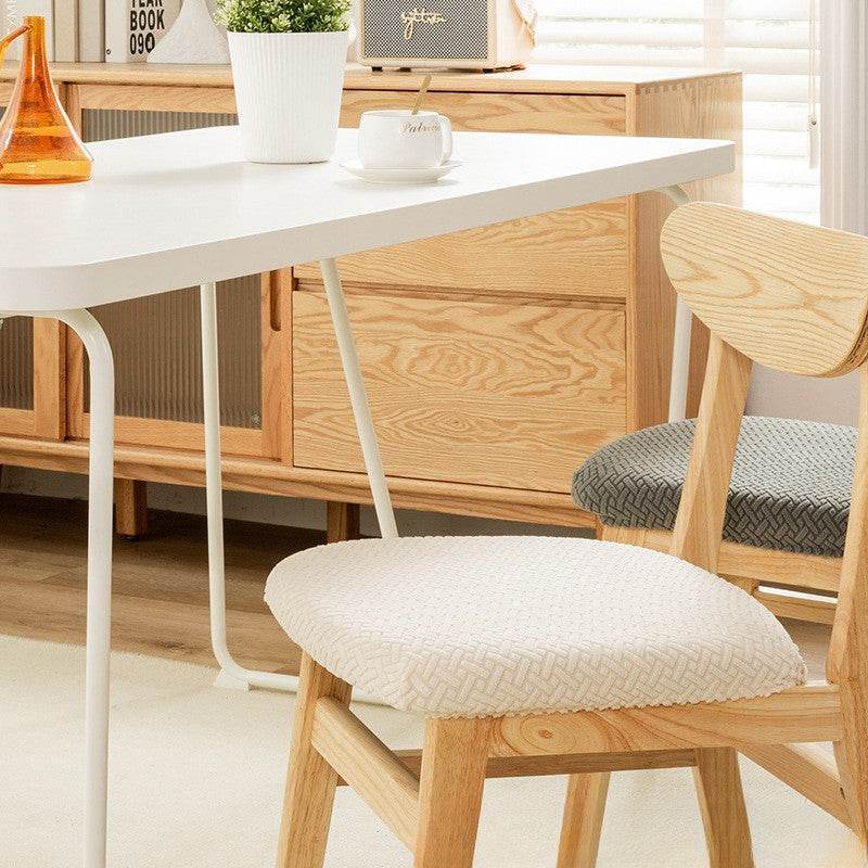 Seat covered with the Cozee Elastic Seat Cover, featuring thick stretch fabric and anti-slip backing for a snug fit on wooden dining chairs or stools, ideal for home, office, or restaurant use