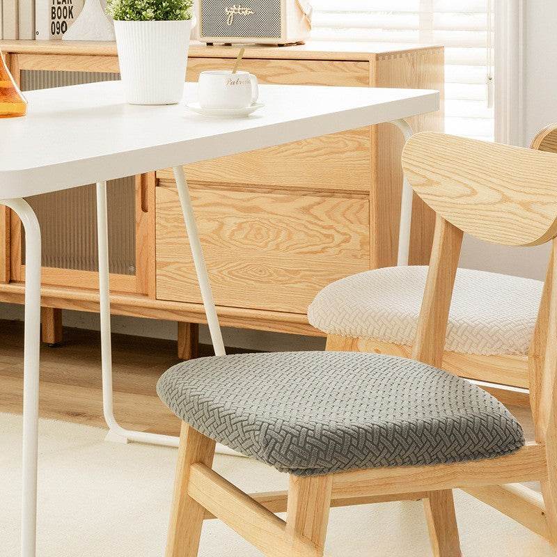 Seat covered with the Cozee Elastic Seat Cover, featuring thick stretch fabric and anti-slip backing for a snug fit on wooden dining chairs or stools, ideal for home, office, or restaurant use
