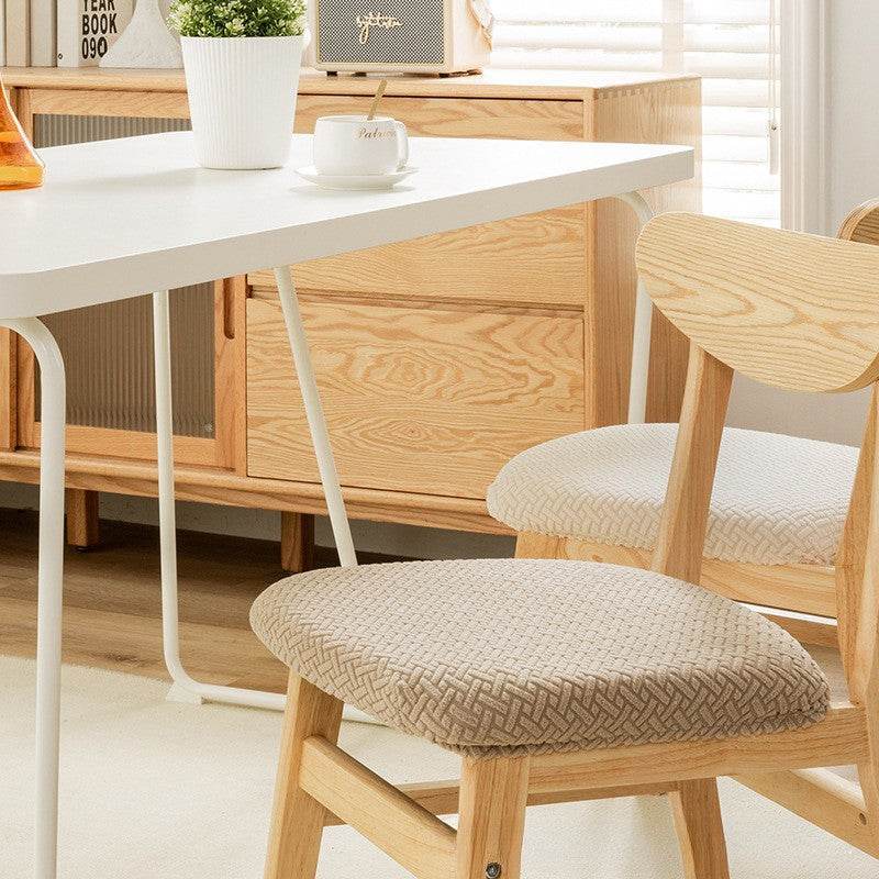Seat covered with the Cozee Elastic Seat Cover, featuring thick stretch fabric and anti-slip backing for a snug fit on wooden dining chairs or stools, ideal for home, office, or restaurant use