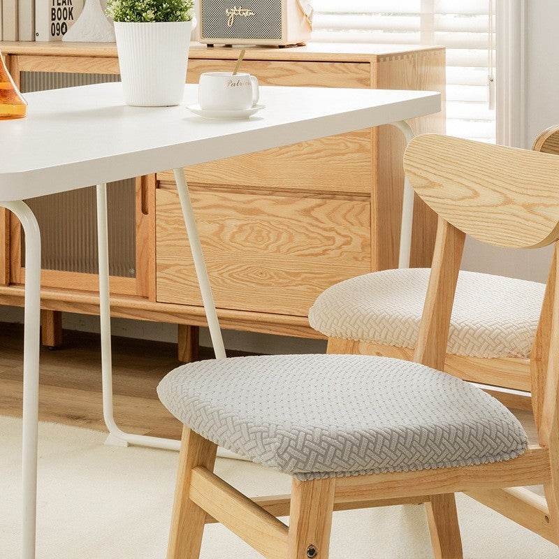 Seat covered with the Cozee Elastic Seat Cover, featuring thick stretch fabric and anti-slip backing for a snug fit on wooden dining chairs or stools, ideal for home, office, or restaurant use