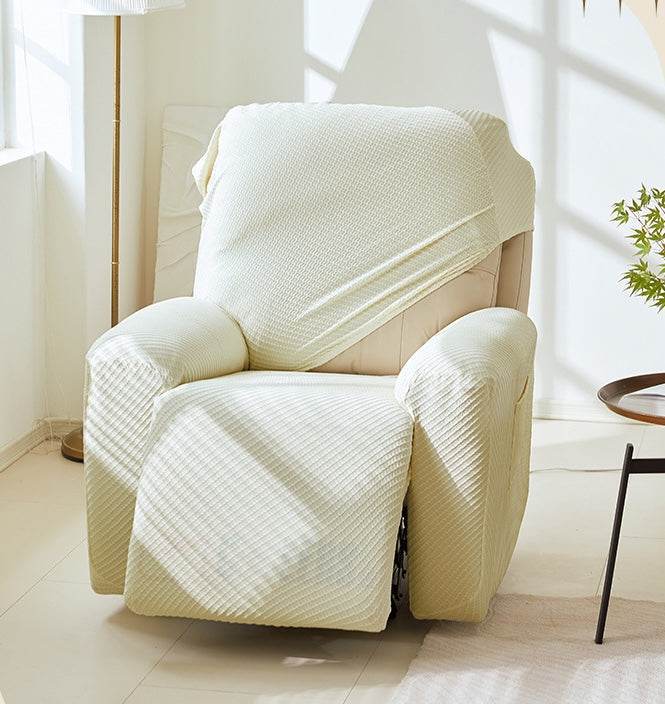 Close-up of hand stretching the EverPlush slipcover fabric, highlighting its elasticity and flexible fit for various sofa sizes
