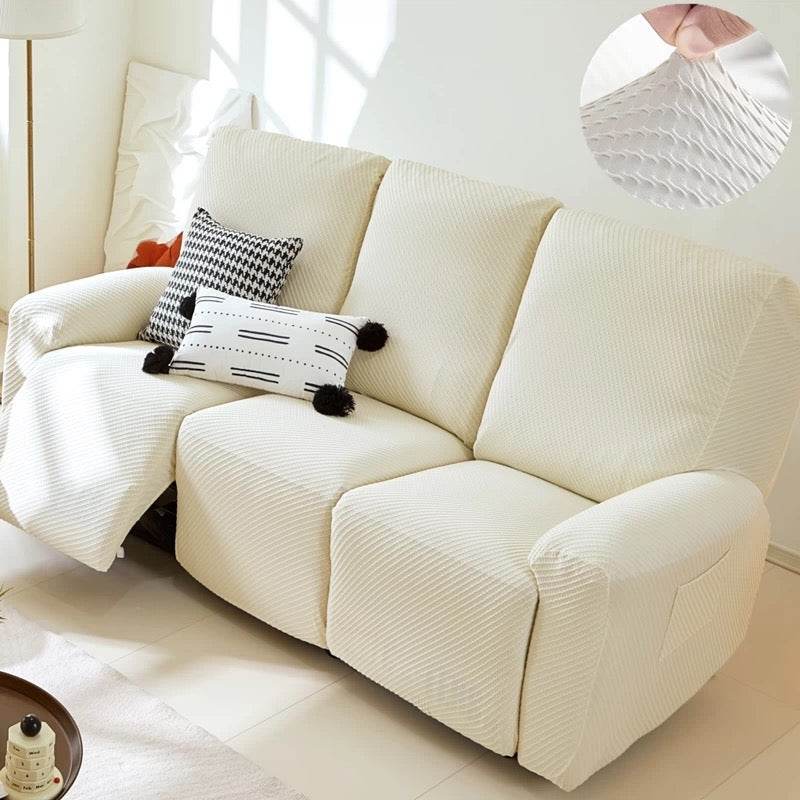 Full view of 3-seater sofa with EverPlush slipcover, showing hand pinching the stretchy, breathable fabric for a snug, flexible fit
