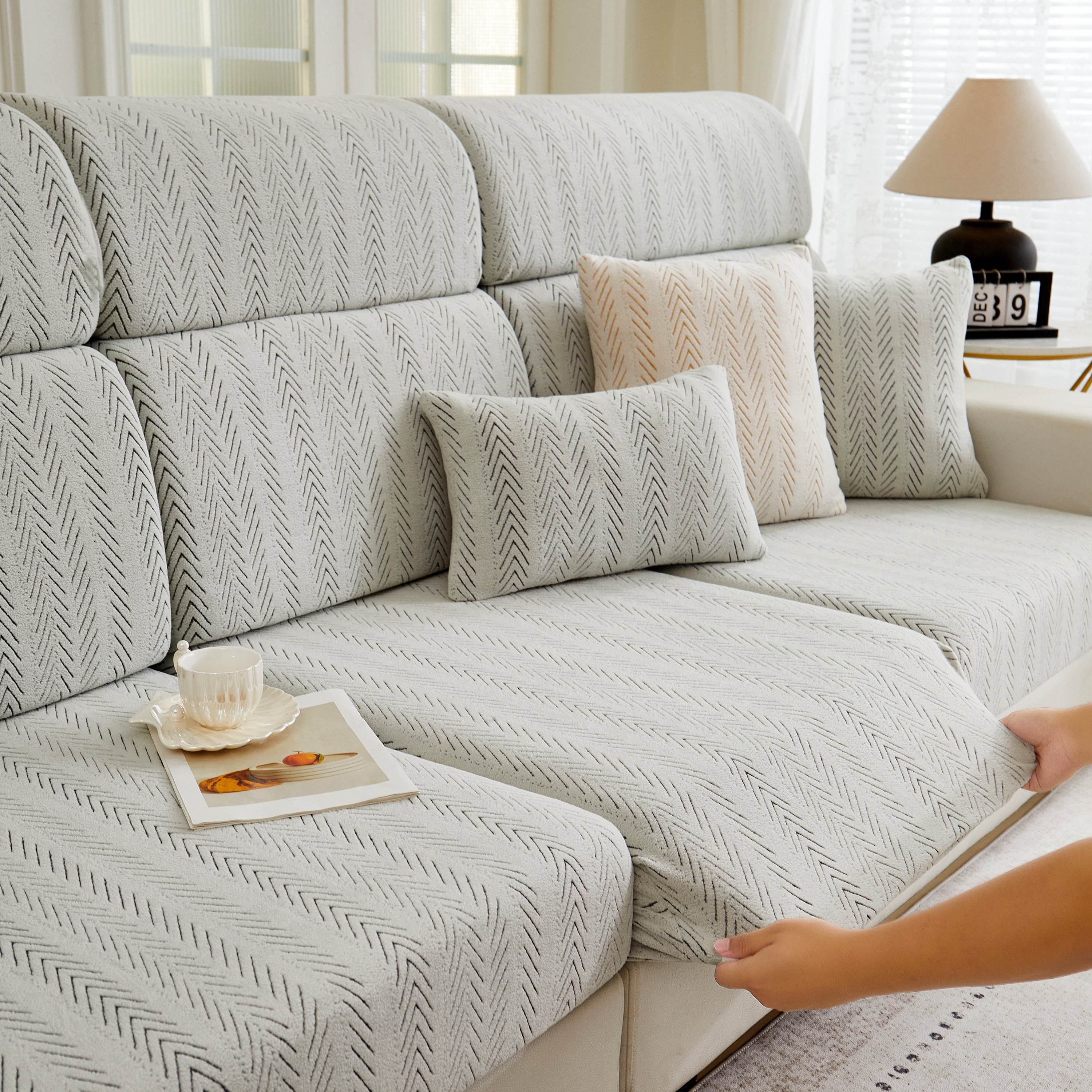 Cozee Herringbone Sofa Cover fabric being stretched, showing flexible elasticity, thick durable weave, and a snug fit for everyday use.