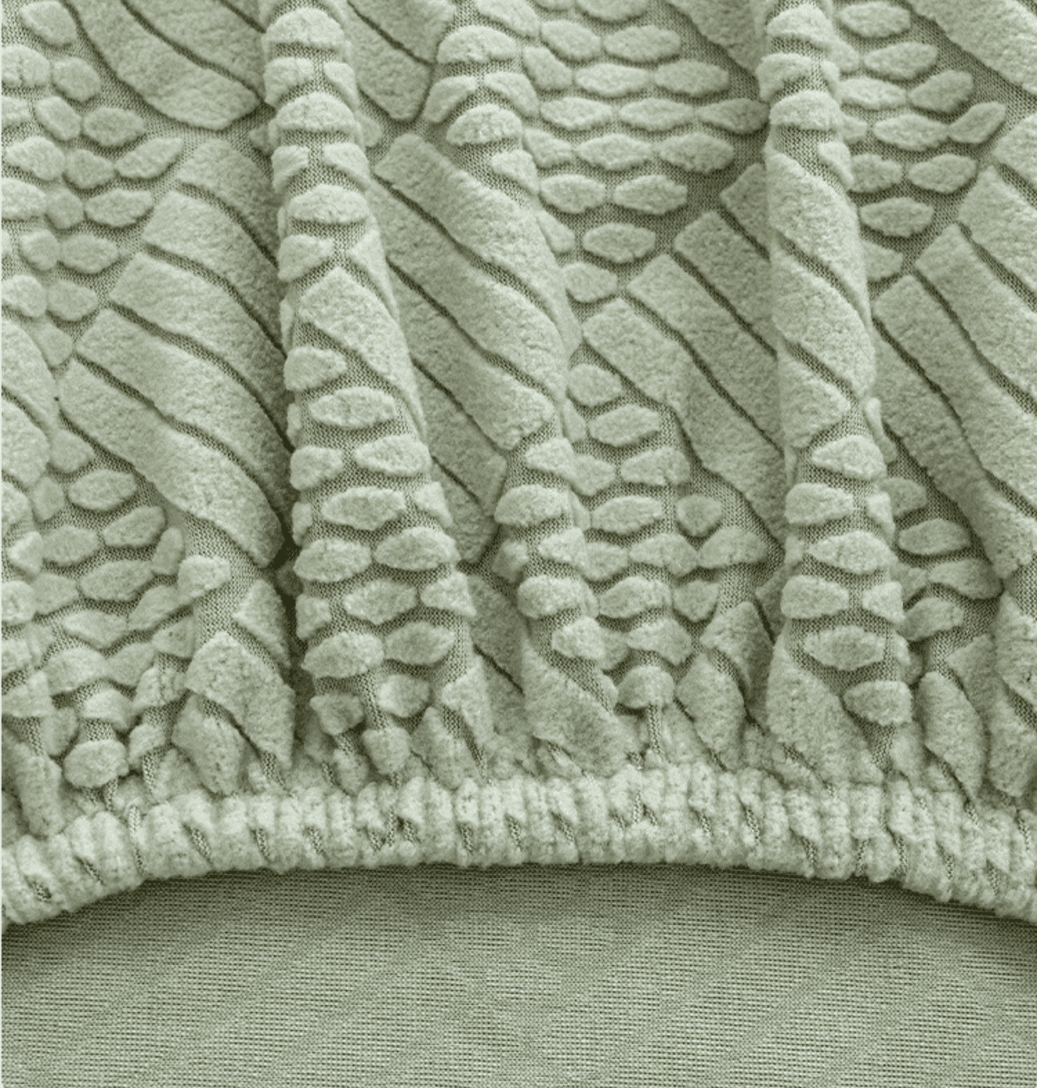 Close-up of jacquard chair cover in mint green showing precise seam detail, highlighting the high-quality stitching and tailored construction of the Cozee Curved Chair Cover