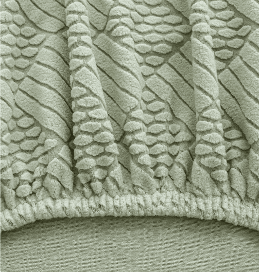 Close-up of jacquard chair cover in mint green showing precise seam detail, highlighting the high-quality stitching and tailored construction of the Cozee Curved Chair Cover