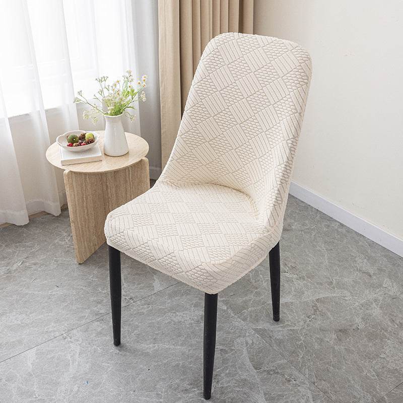 Dining chair covered with the Cozee Jacquard Curved Chair Cover, featuring a refined jacquard texture and flexible stretch fit that hugs curved backs for a sleek, elegant look and everyday protection