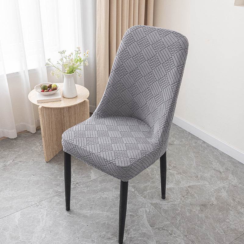Dining chair covered with the Cozee Jacquard Curved Chair Cover, featuring a refined jacquard texture and flexible stretch fit that hugs curved backs for a sleek, elegant look and everyday protection