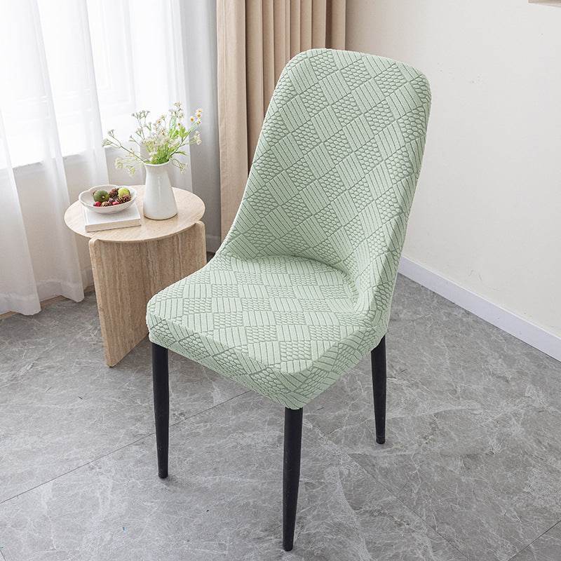 Dining chair covered with the Cozee Jacquard Curved Chair Cover, featuring a refined jacquard texture and flexible stretch fit that hugs curved backs for a sleek, elegant look and everyday protection