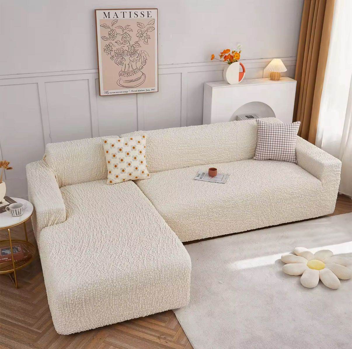 Full view of L-shaped sofa with chaise fully covered in Cozee Microfiber Slipcover, showing a smooth, tailored fit with soft, textured fabric for all-around protection and comfort