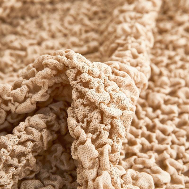 Close-up of beige microfiber slipcover fabric showing soft, textured weave for a smooth, comfortable finish and everyday durability