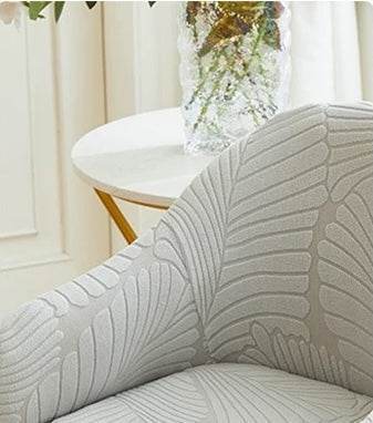 Close-up of soft stretch-velvet fabric with embossed leaf pattern, highlighting the elegant texture of the SoftWeave chair cover