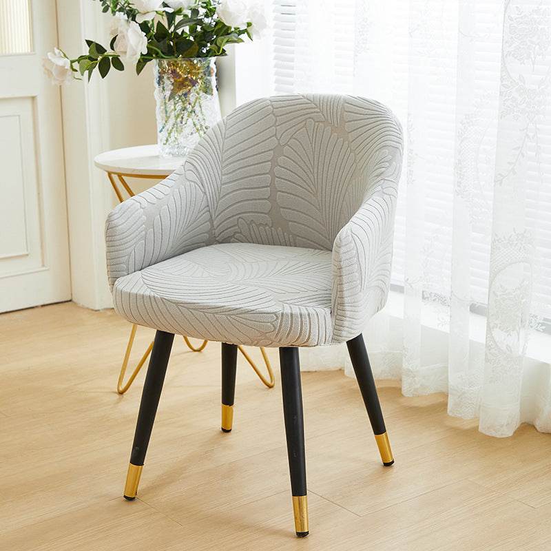 Full coverage chair cover with ultra-soft stretch velvet fabric, designed to fit curved-back chairs with high armrests and featuring an elegant embossed leaf pattern