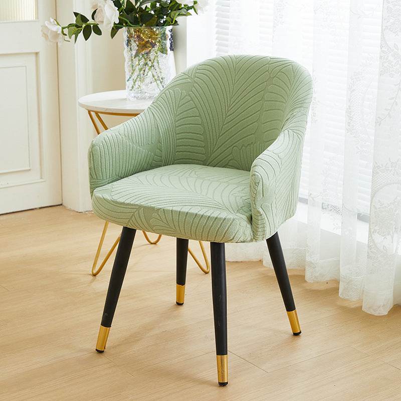 Full coverage chair cover with ultra-soft stretch velvet fabric, designed to fit curved-back chairs with high armrests and featuring an elegant embossed leaf pattern