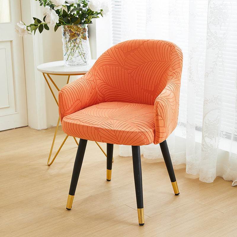 Full coverage chair cover with ultra-soft stretch velvet fabric, designed to fit curved-back chairs with high armrests and featuring an elegant embossed leaf pattern