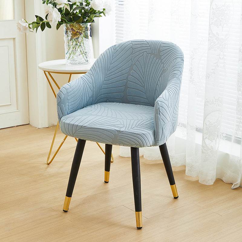 Full coverage chair cover with ultra-soft stretch velvet fabric, designed to fit curved-back chairs with high armrests and featuring an elegant embossed leaf pattern