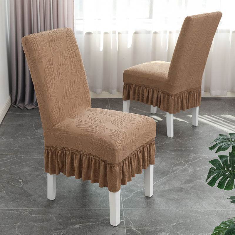 Dining chair fully covered with the Cozee SoftWeave Skirted Chair Cover, featuring a snug stretch fit and elegant skirt that hides chair legs while offering breathable comfort and full protection