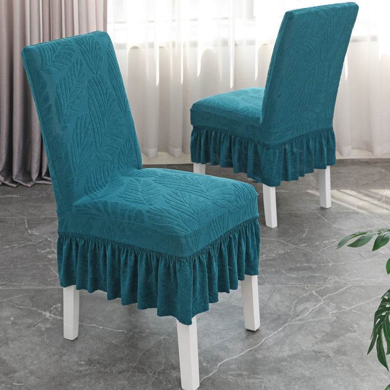 Dining chair fully covered with the Cozee SoftWeave Skirted Chair Cover, featuring a snug stretch fit and elegant skirt that hides chair legs while offering breathable comfort and full protection