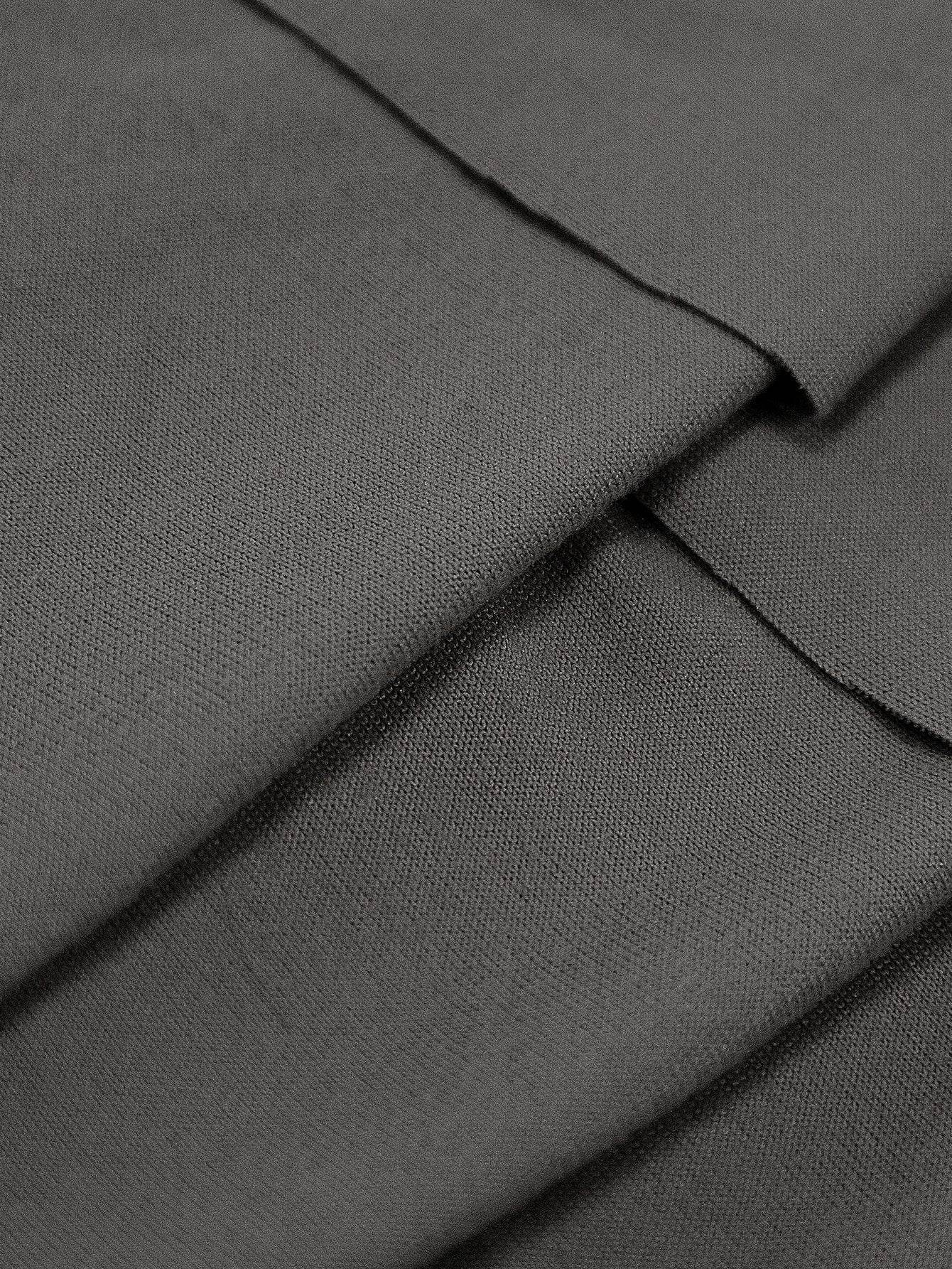 Close-up of dark gray chair cover fabric with visible stitching and soft folds, showcasing the quality craftsmanship and flexible fit of the Cozee Stretch Fit Chair Cover