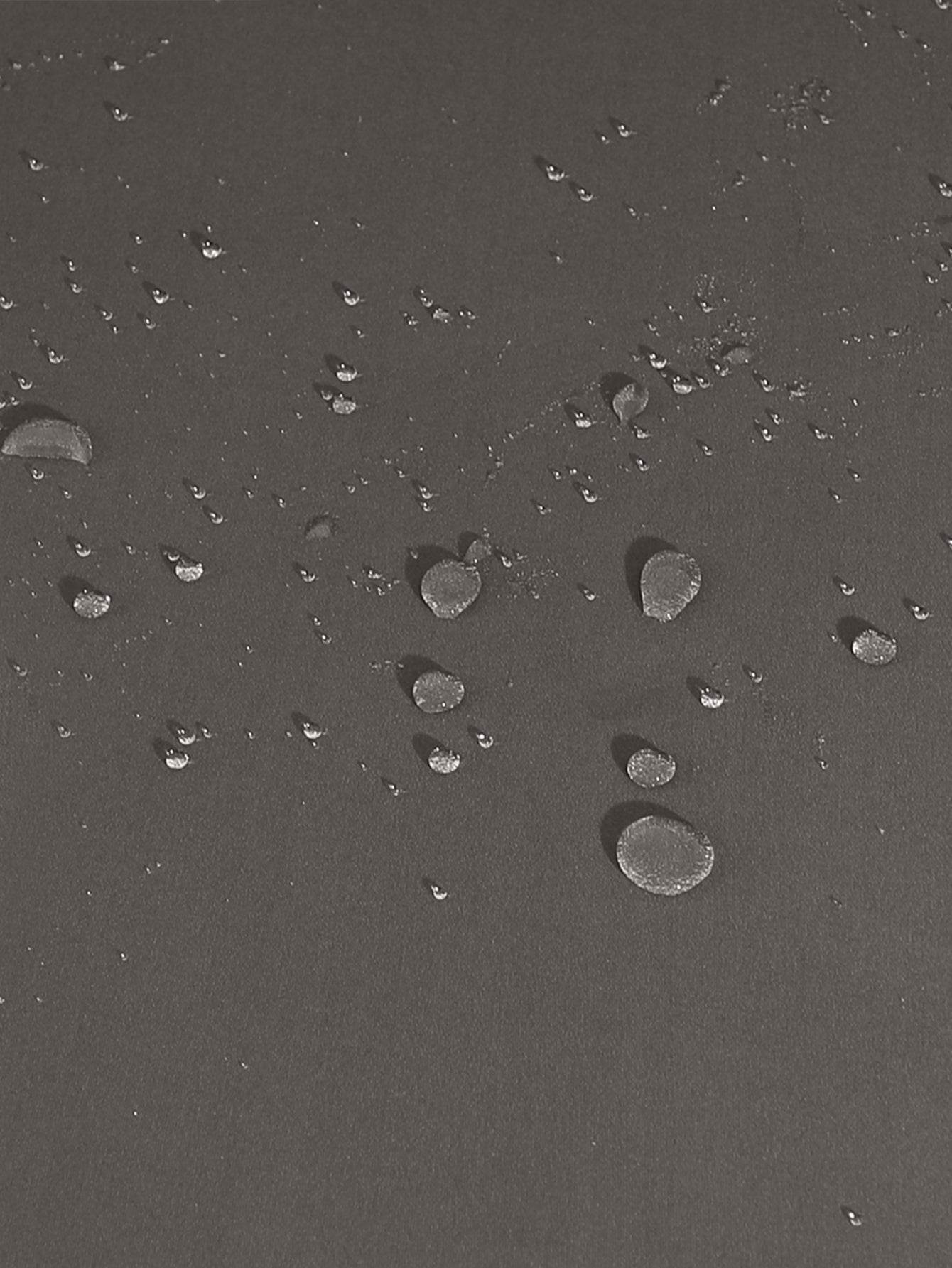 Close-up of water droplets on the surface of the Cozee Stretch Fit Chair Cover, highlighting its protective, water-resistant fabric that guards against spills and stains