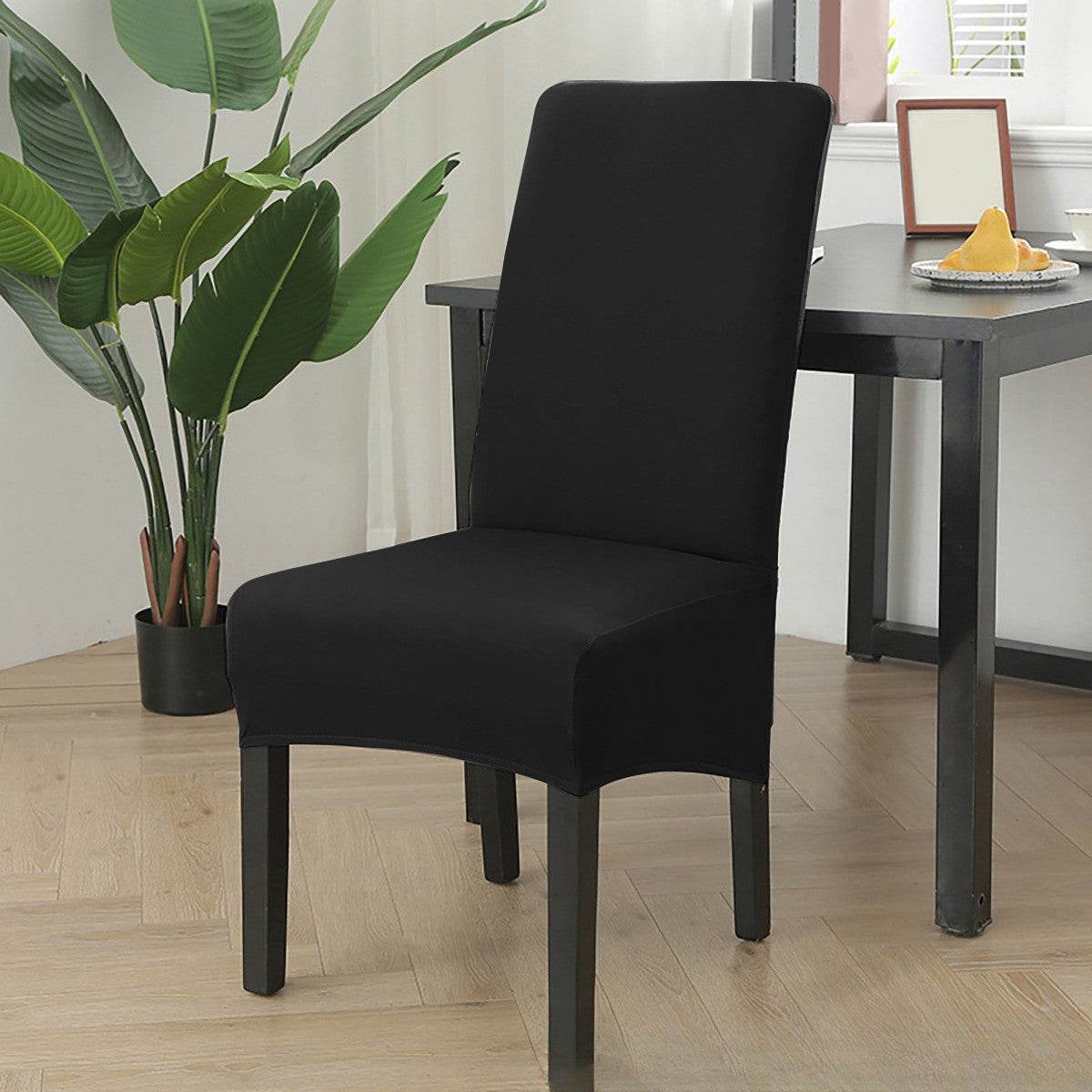 Dining chair fitted with the Cozee Stretch Fit Chair Cover, featuring a smooth, snug fit with soft stretchy fabric that protects against spills, stains, and daily wear