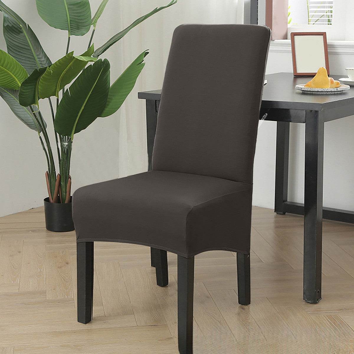 Dining chair fitted with the Cozee Stretch Fit Chair Cover, featuring a smooth, snug fit with soft stretchy fabric that protects against spills, stains, and daily wear