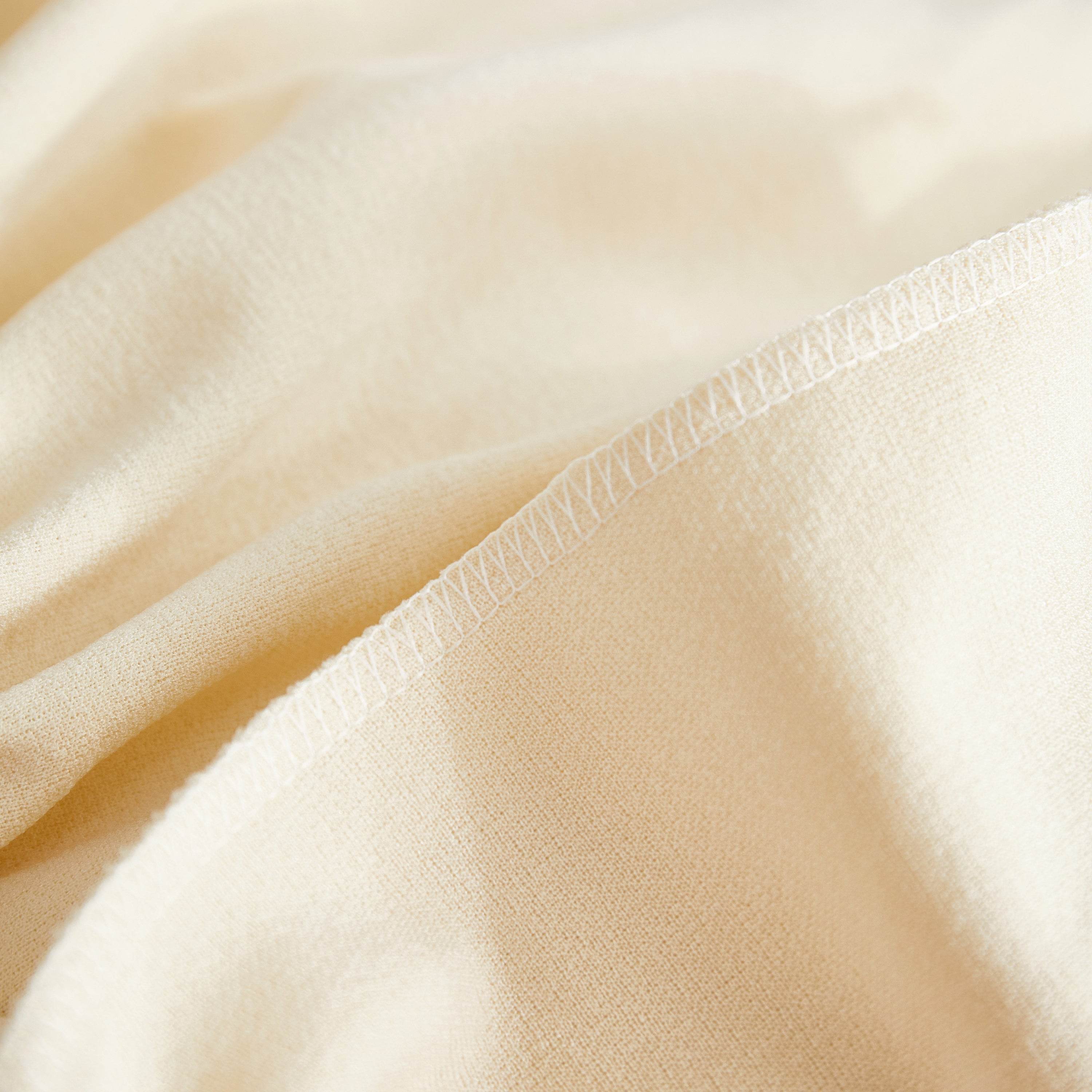 Close-up of soft teddy fabric showing the seam—durable couch cover stitching for a snug fit and long-lasting protection.
