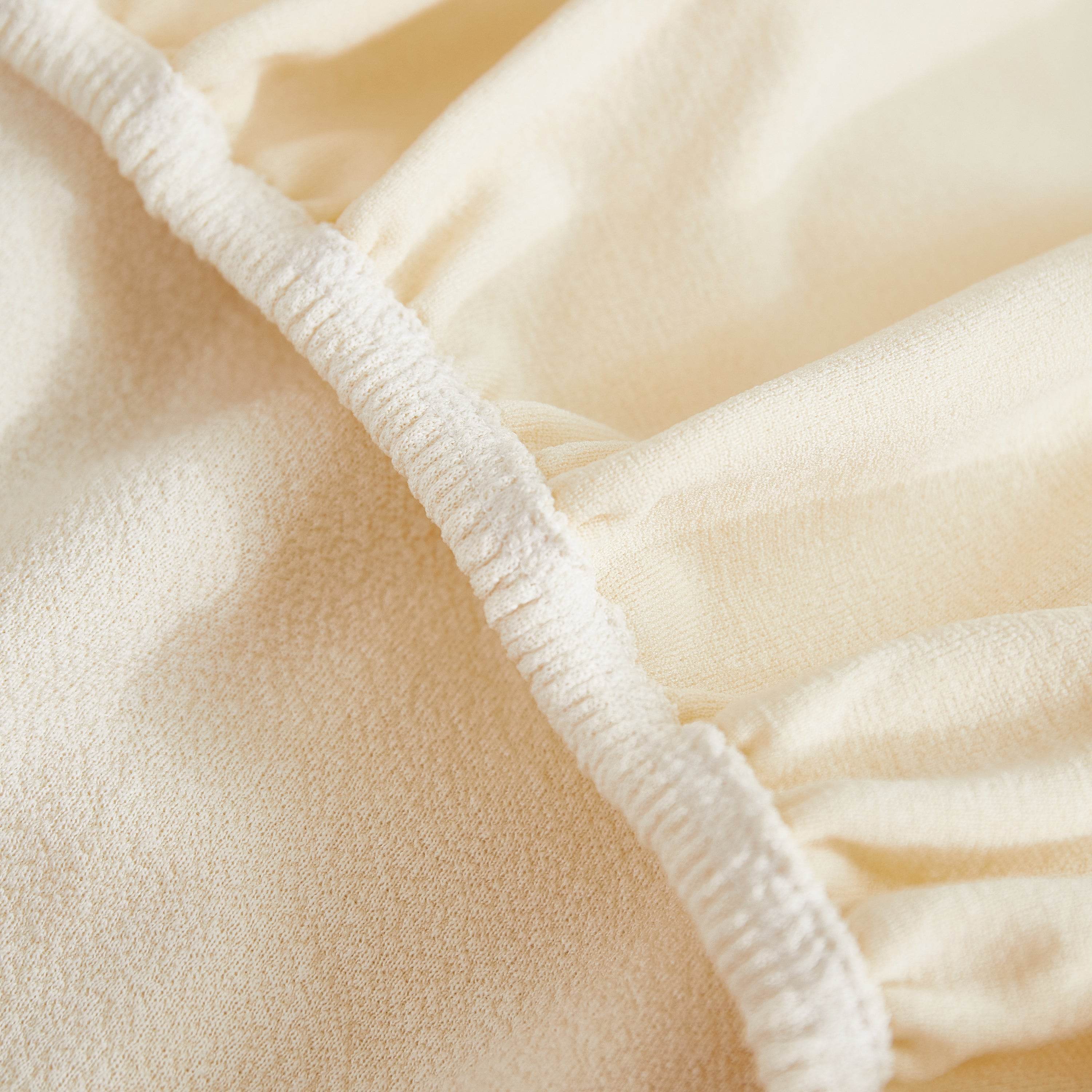 Close-up of teddy fleece fabric showing textured border—premium couch cover detail for added style, durability, and snug fit.