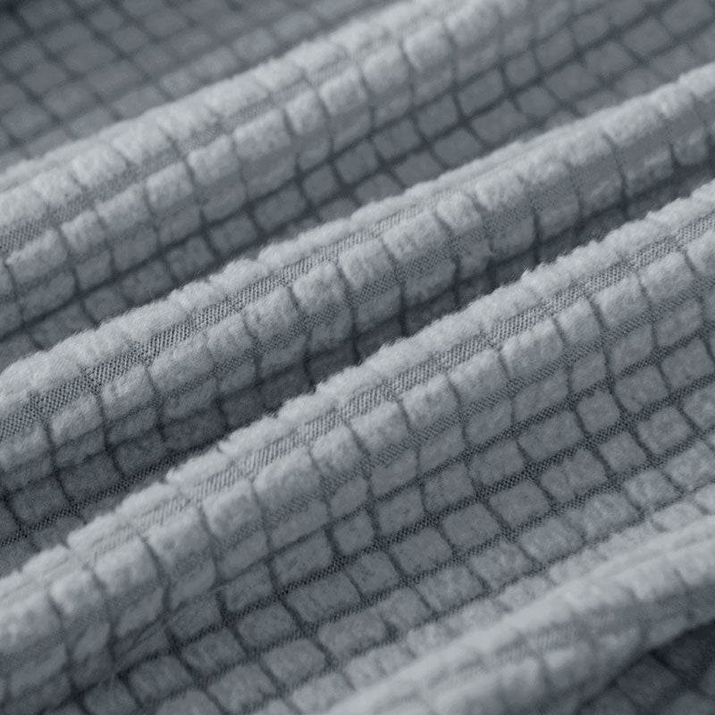 Close-up of a soft fleece fabric fold from the Cozee Timeless Arm Cover, highlighting its plush texture, gentle drape, and cozy material quality