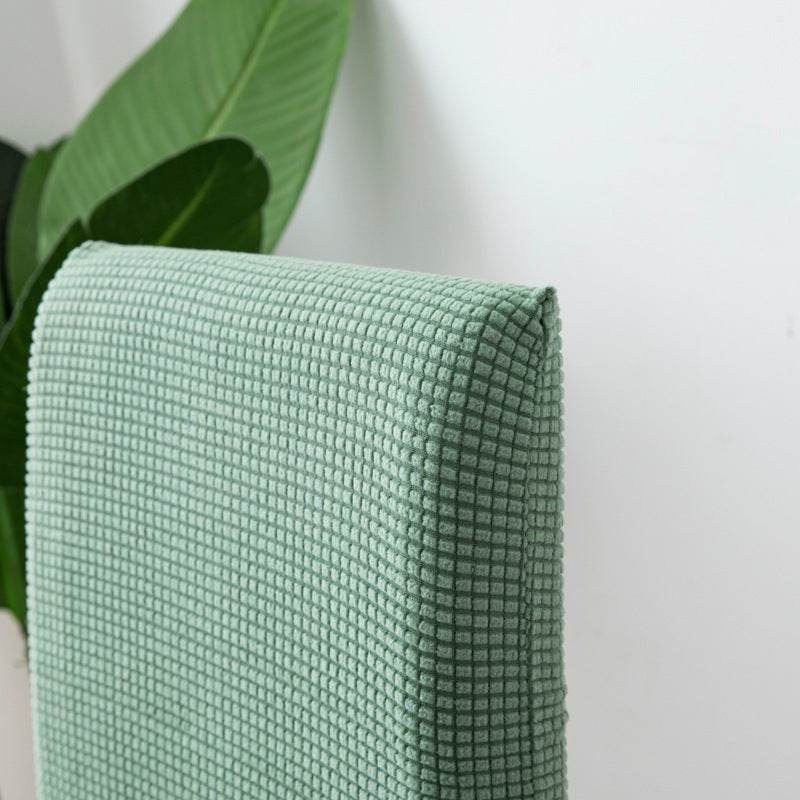Close-up of mint textured chair fabric, highlighting the soft fleece material and subtle stretch of the Cozee Timeless Chair Cover for cozy comfort and everyday protection