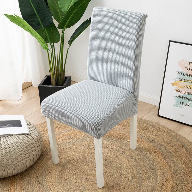 Full view of a chair fitted with the Cozee Timeless Chair Cover, featuring soft, plush fleece fabric and a secure stretch fit that offers full protection against dust, spills, and pet hair