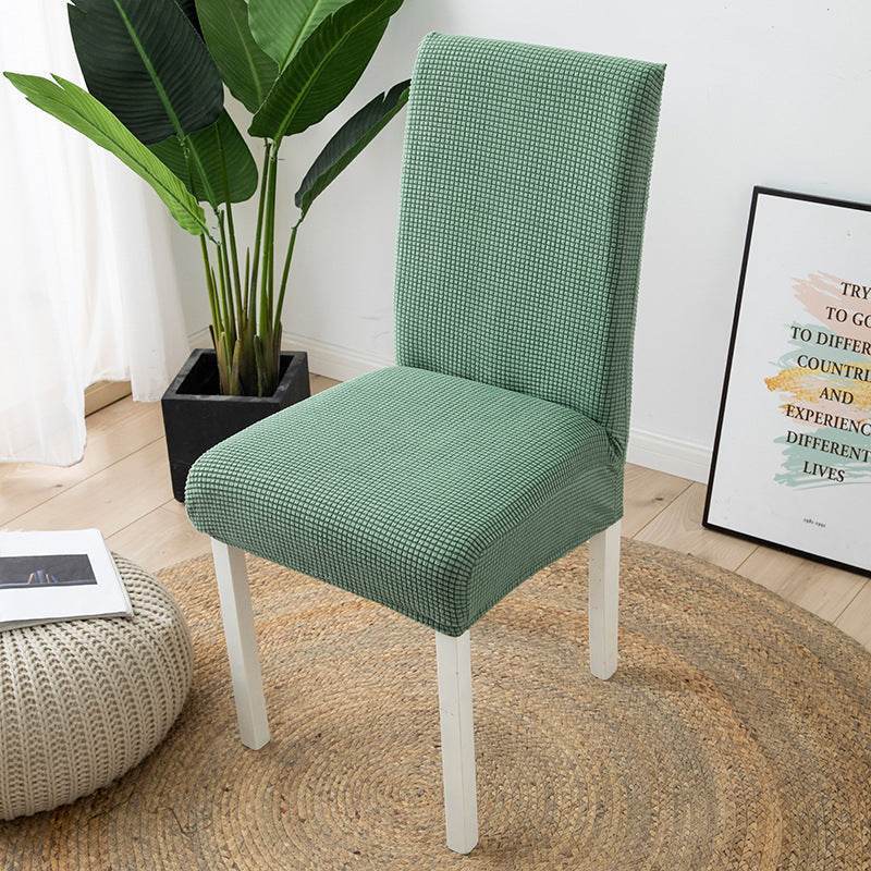 Full view of a chair fitted with the Cozee Timeless Chair Cover, featuring soft, plush fleece fabric and a secure stretch fit that offers full protection against dust, spills, and pet hair