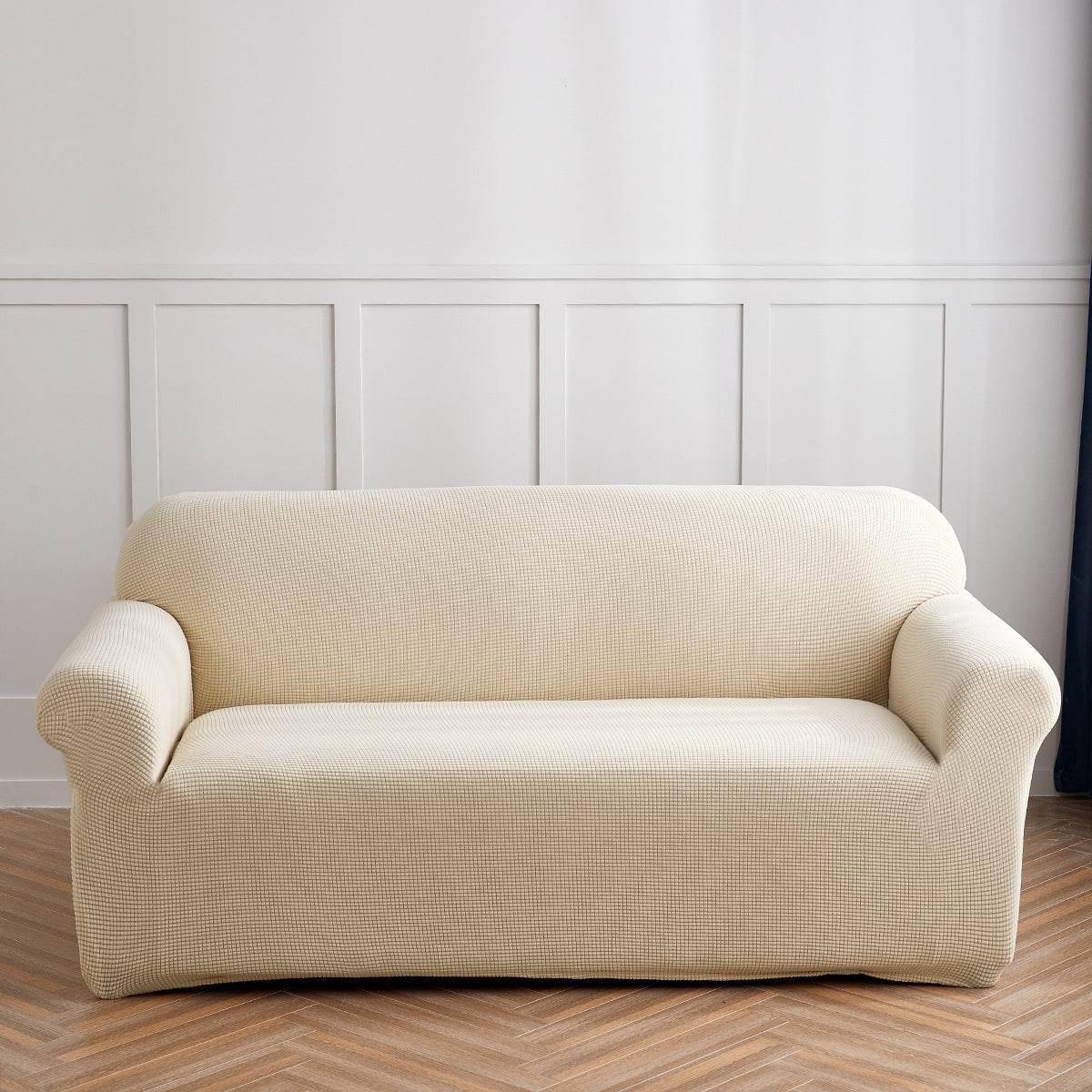 Sofa fitted with the Cozee Timeless Slipcover, featuring ultra-soft plush fleece fabric and a high-stretch, snug fit that offers cozy comfort and full coverage protection from spills, dust, and pet hair