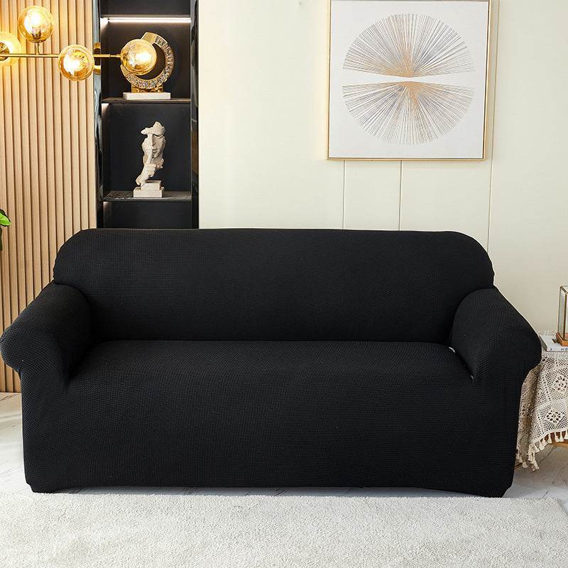 Sofa fitted with the Cozee Timeless Slipcover, featuring ultra-soft plush fleece fabric and a high-stretch, snug fit that offers cozy comfort and full coverage protection from spills, dust, and pet hair