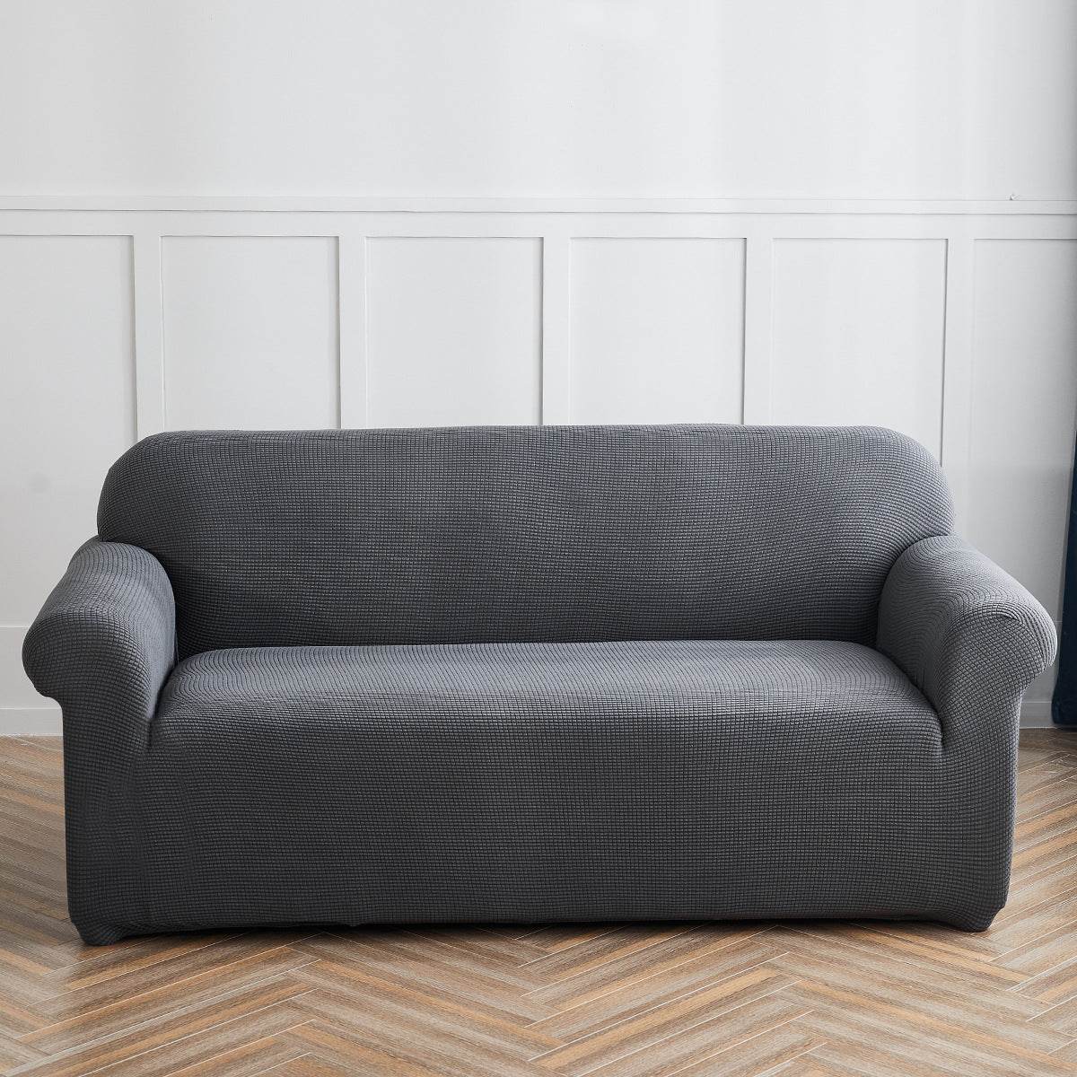 Sofa fitted with the Cozee Timeless Slipcover, featuring ultra-soft plush fleece fabric and a high-stretch, snug fit that offers cozy comfort and full coverage protection from spills, dust, and pet hair