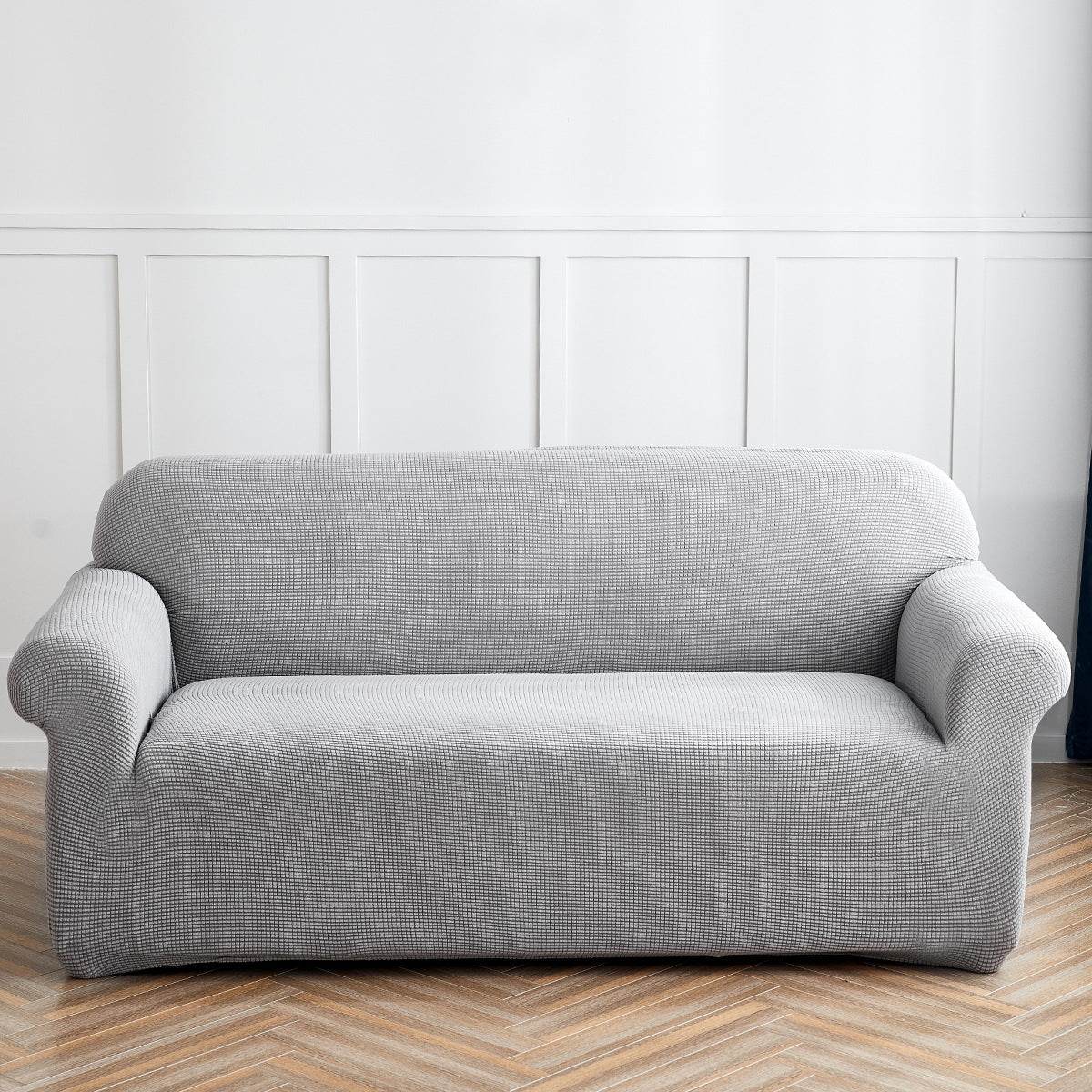 Sofa fitted with the Cozee Timeless Slipcover, featuring ultra-soft plush fleece fabric and a high-stretch, snug fit that offers cozy comfort and full coverage protection from spills, dust, and pet hair