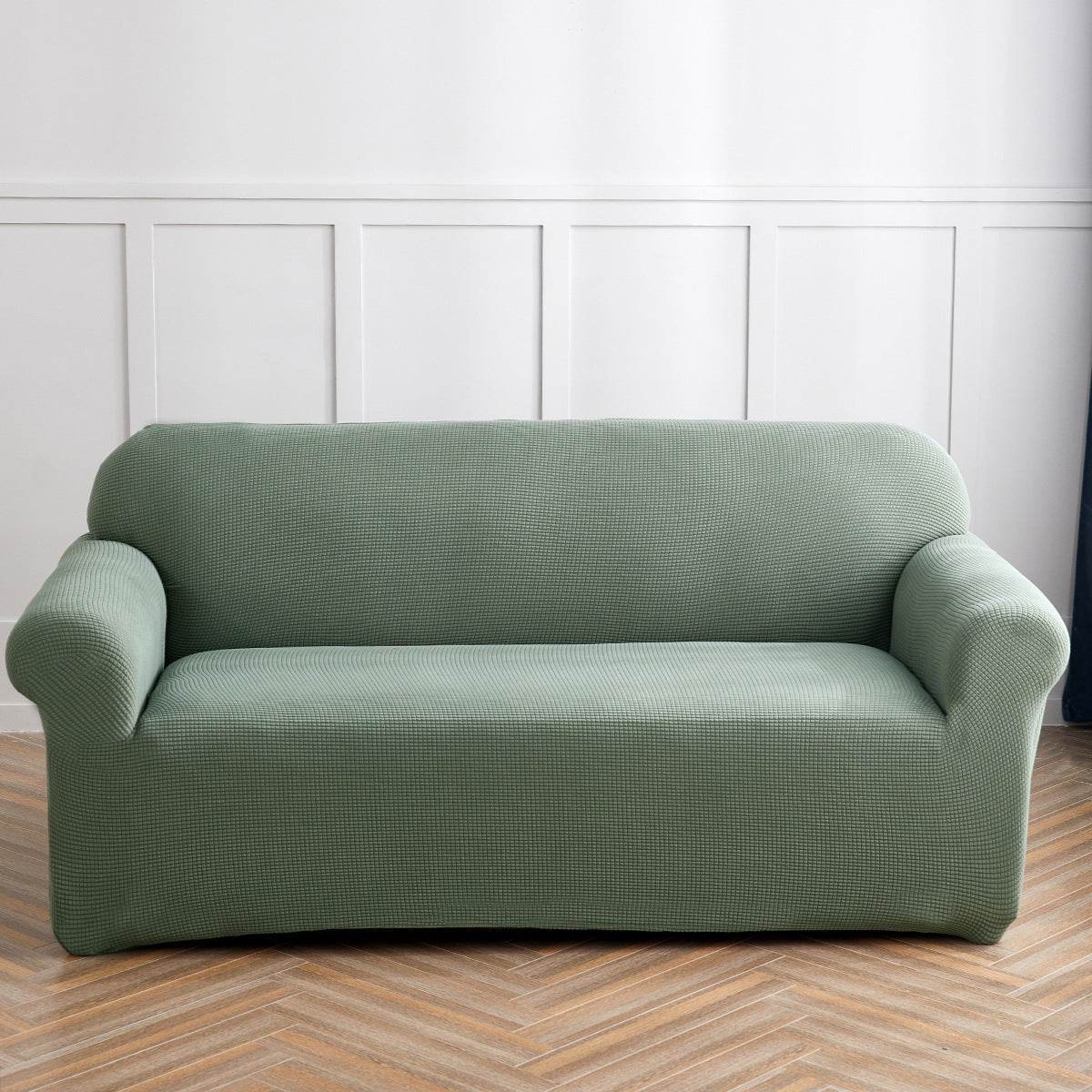 Sofa fitted with the Cozee Timeless Slipcover, featuring ultra-soft plush fleece fabric and a high-stretch, snug fit that offers cozy comfort and full coverage protection from spills, dust, and pet hair