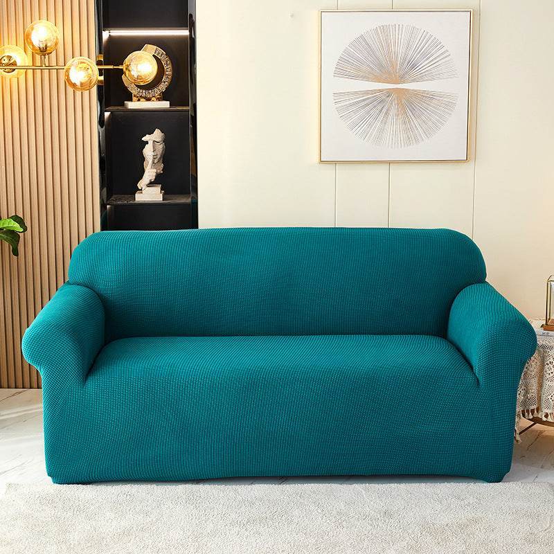 Sofa fitted with the Cozee Timeless Slipcover, featuring ultra-soft plush fleece fabric and a high-stretch, snug fit that offers cozy comfort and full coverage protection from spills, dust, and pet hair