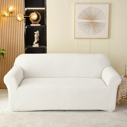 Sofa fitted with the Cozee Timeless Slipcover, featuring ultra-soft plush fleece fabric and a high-stretch, snug fit that offers cozy comfort and full coverage protection from spills, dust, and pet hair