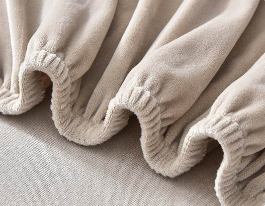 Close-up of beige microfiber fleece fabric with textured edges, highlighting the soft, cozy feel and detailed finish of the Cozee Plush Futon Slipcover