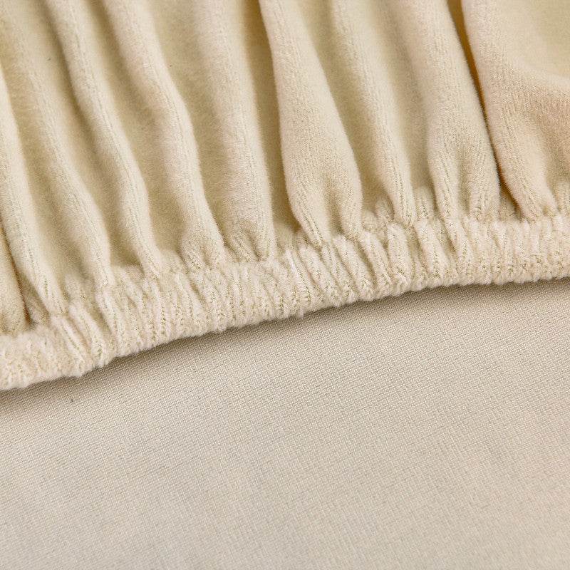 Close-up of soft, plush fabric fitted snugly around a corner, highlighting the stretch-fit design and smooth texture of the Cozee Ultra Soft Plush Slipcover