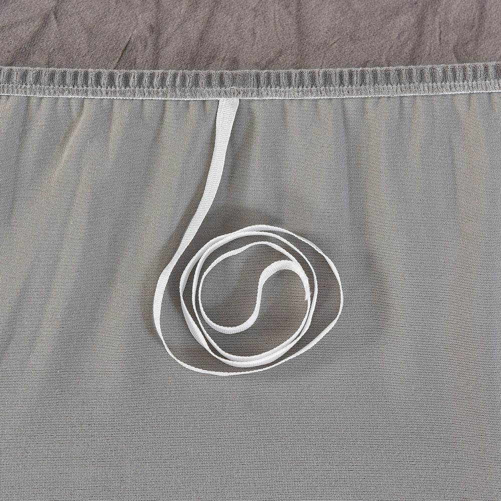 Close-up of breathable mesh fabric paired with a white elastic band, highlighting the secure fit and underside construction of the Cozee Ultra Soft Plush Slipcover
